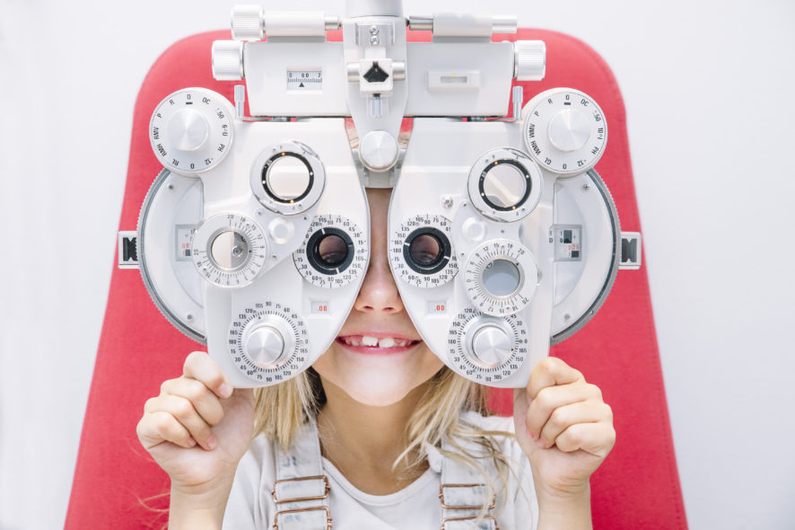 concept vision testing. child girl with eyeglasses