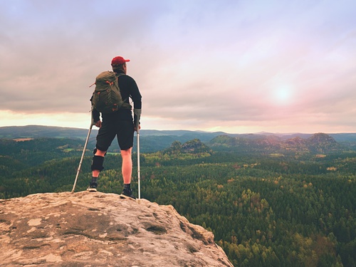 Man hiker Wearing Supportive Leg Brace and gainst the cruthes.